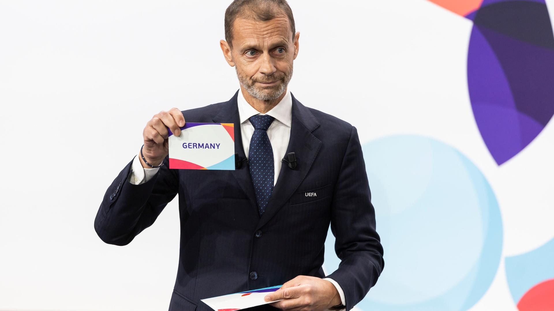 UEFA-Präsident Aleksander Ceferin präsentiert einen Zettel mit der Aufschrift "Germany" (Deutschland)  