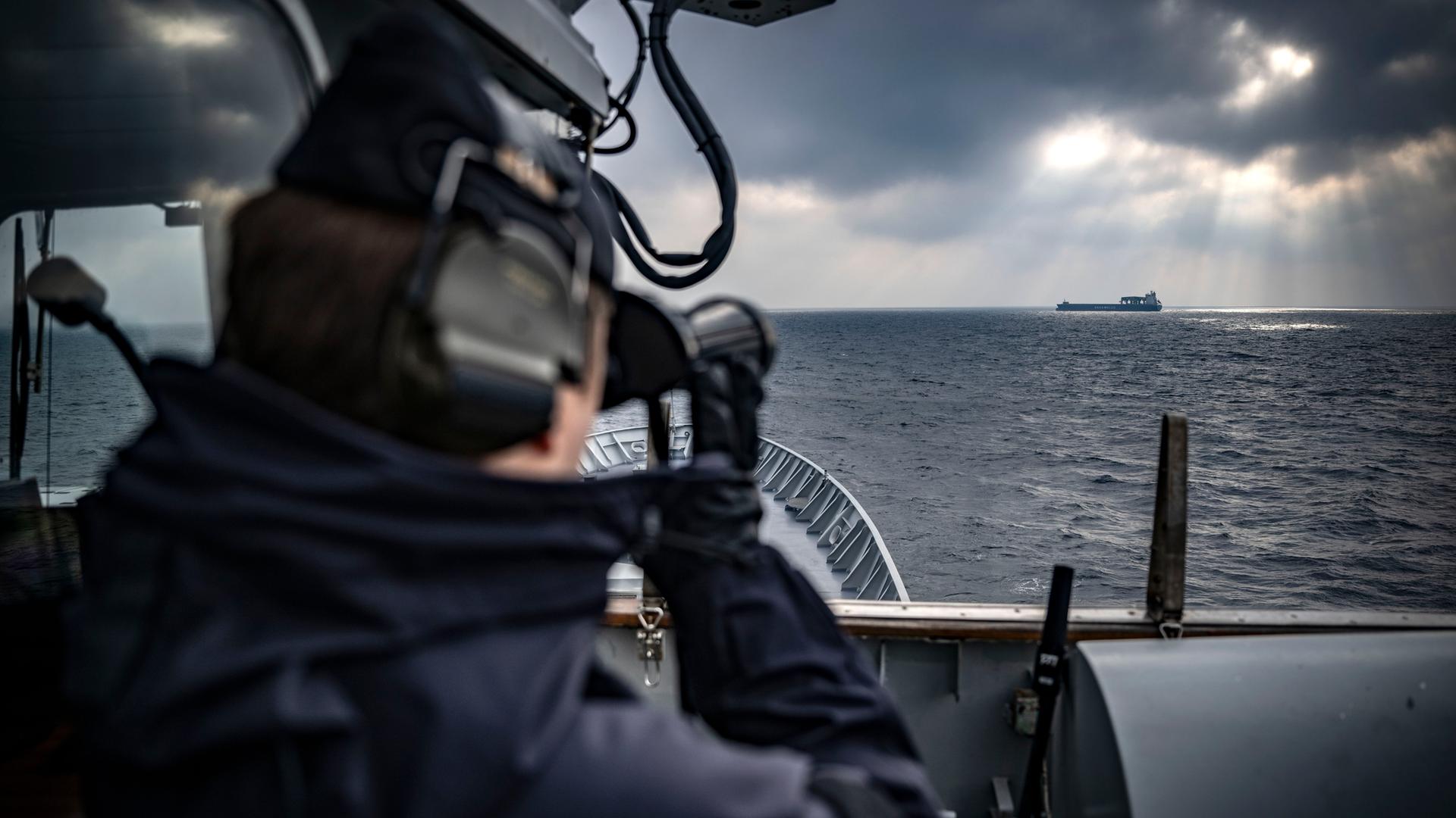 Ein Frachtschiff am Horizont wird vom Brückendeck eines schwedischen Nato-Schiffes aus durch das Fernglas des Ausgucks betrachtet. Ein Frachtschiff am Horizont wird vom Brückendeck eines schwedischen Nato-Schiffes aus durch das Fernglas des Ausgucks betrachtet.